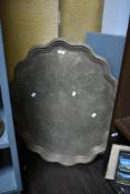A large Indian brass scallop shaped tray, with engraved design, and measuring 81cm in diameter
