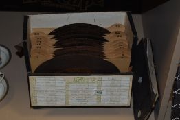 A collection of metal Phonograph 'discs' in a carry case.