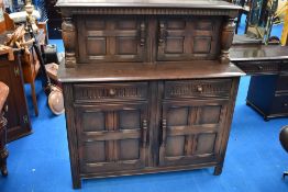 A vintage Priory or dark Ercol court cupboard