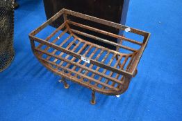 A traditional cast iron dog fire grate of trough form
