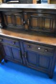 A dark stained Ercol court cupboard
