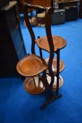 An early 20th Century mahogany folding cake stand having five tiers
