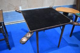 A vintage card table having fold out coin holders/ashtrays