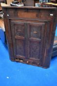 A period oak corner cupboard of large proportions