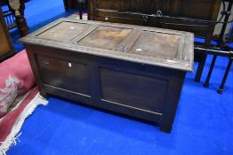 A traditional oak kist having panelled lid