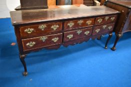 A period oak dresser base, having six drawers with Georgian brass handles and cabriole legs, width