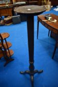 A 19th Century torchere having turned column and triple splay legs