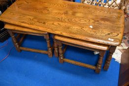 A modern mid stain Ercol coffee table nest