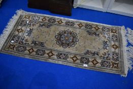 An Oriental silk fireside rug, approx. 122 x 62cm