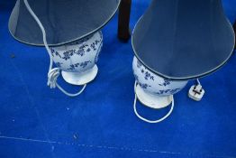 A pair of blue and white ceramic table lamps