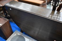 A dark stained Ercol narrow gateleg dining table