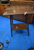 A reproduction Victorian style occasional table with turned legs and undertier