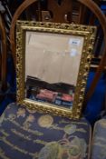 A small gilt frame wall mirror