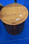 A modern circular storage stool with faux book design
