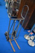 A vintage piano or similar moving trolley, with revolving stair wheels
