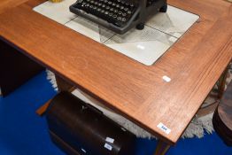 A vintage teak extending dining table with tiles inset