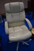 A cream leather office swivel chair