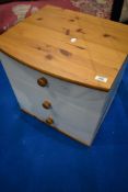 A modern white laminate and pine bedside drawer chest