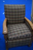 An early 20th Century oak framed easy chair with later check upholstery
