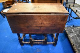 A 19th Century gateleg dining table having turned frame, width approx. 74cm