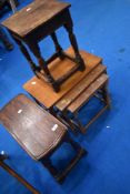 A selection of traditional oak occasional tables including nest