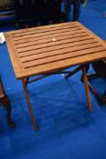 A teak folding small garden table