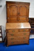 A 19th Century golden oak bureau bookcase having inlaid shell and moth designs , brass hinges to