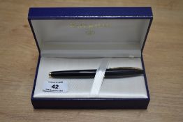 A boxed Waterman Carene cartridge/converter fountain pen in black with gold trim having Waterman 18k