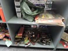 Two shelves of playworn 0 Gauge and Triang Minic Motorways track, wagons and accessories