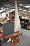 A wooden model Pond Yacht, no radio control unit present, sail present, height 250cm, sail height