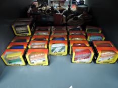 A shelf of 1983 Corgi die-cast Buses, Suntrekker, Routemaster and similar, all in yellow, red &