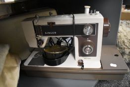 A vintage Singer electric sewing machine with instructions.