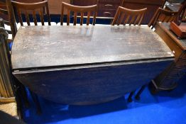A late 19th Century oak gateleg table having cabriole legs and oval top, dimensions approx W137cm,