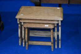 A stripped nest of three occasional tables