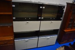 A pair of vintage laminate monochrome wall units having glazed display section over drop flap and