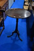 A George III mahogany tripod table, having damage to lip top