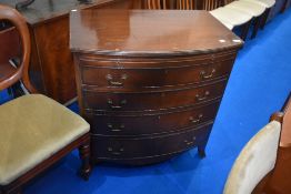 A reproduction Regency style bow front chest of four long drawers, with brushing slide, width