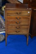 An early 20th Century mahogany five drawer music cabinet with typical drop flap drawer fronts,