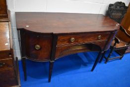 A Regency mahogany sideboard having central drawer above recess , flanked by cupboard , cellarette
