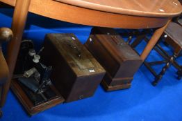 Two vintage sewing machines in cases