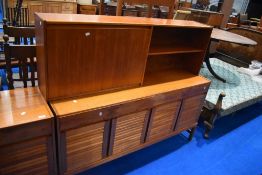 A vintage teak side unit , labelled for McIntosh , having cocktail and open shelves to top and