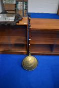 A traditional copper and brass warming pan having mahogany handle