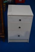 A vintage painted bedside chest