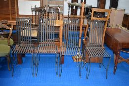 A set of four modern metal dining or garden chairs