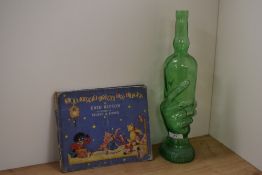 An interesting moulded green glass wine bottle, in the form on a hand, measuring 36cm tall, and a
