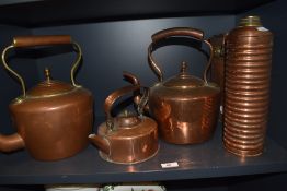 Two 19th Century copper and brass kettles, a smaller kettle, and a ribbed Tala copper flask