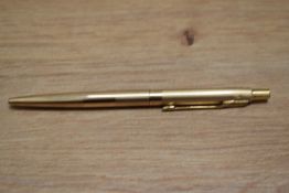 A Parker ballpoint pen in rolled gold with engine turned decal