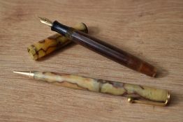 A Parker Moderne Duette button fill fountain pen and propelling pencil in cream with red lines