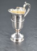 A Queen Elizabeth II silver cream jug, a reproduction of a 17th century ewer of heavy gauge with