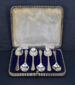 *Golfing interest, a cased set six of George V silver teaspoons, the trefoil surmounts with